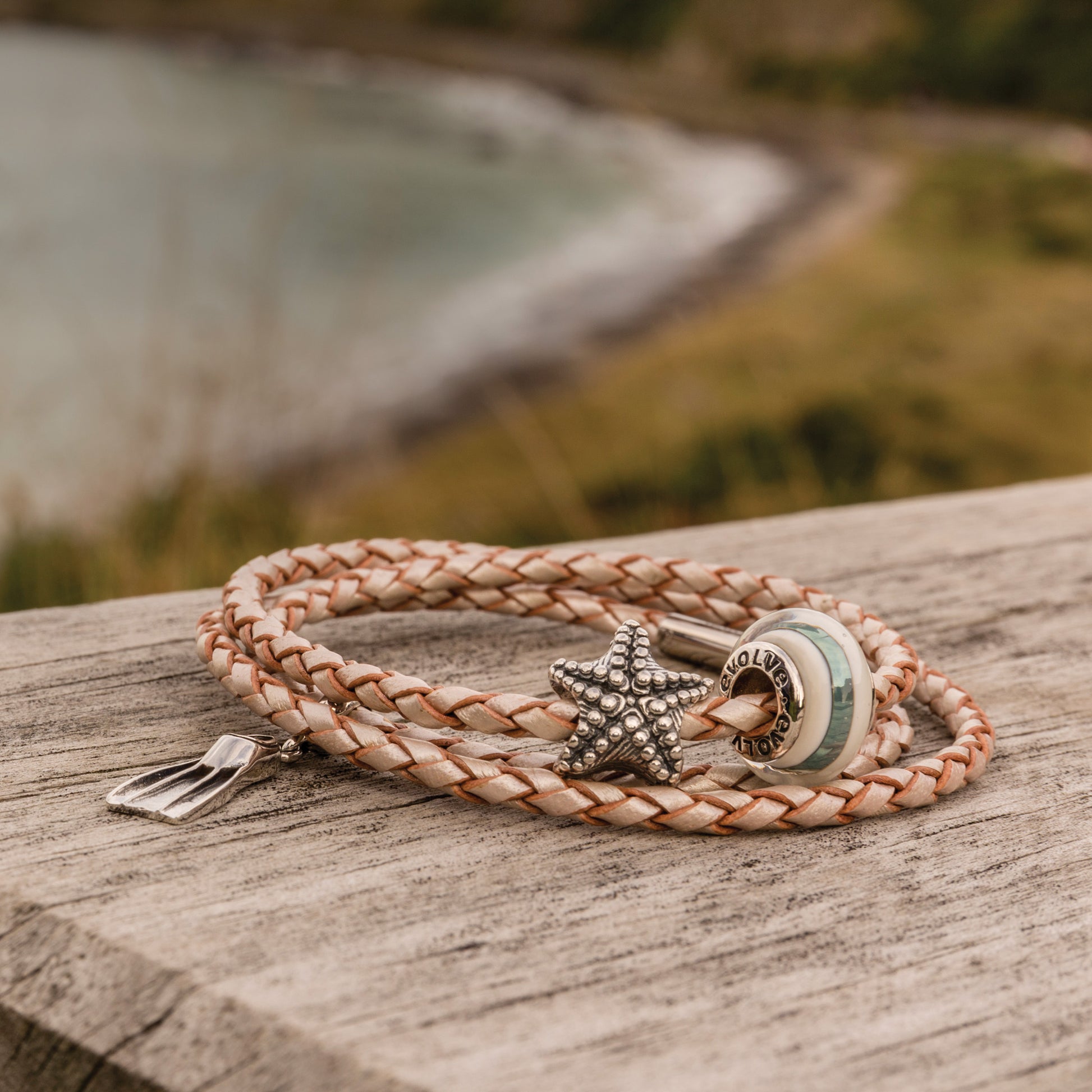 Bracelet with starfish, diving fin and Rakaia charm on a wooden surface