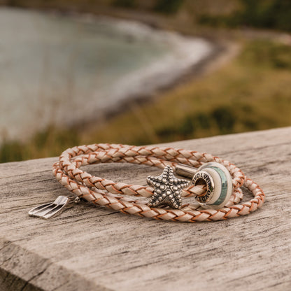 Bracelet with starfish, diving fin and Rakaia charm on a wooden surface
